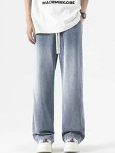 Men’s full size wide leg jeans in light-wash denim with a relaxed fit and white drawstring waistband