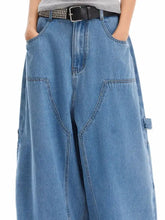 Men’s light-wash blue denim wide-leg jeans with pockets and a studded black belt in plus size wide leg fit