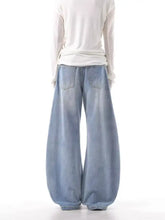 Men’s light-wash denim wide leg jeans with relaxed silhouette and elastic cuffs featuring side stripes plus size