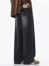Men’s full size black wide-leg denim jeans with faded distressed finish and relaxed fit stitching detail