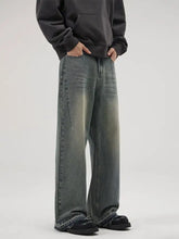 Men’s full size wide leg relaxed fit jeans in faded gray denim with frayed hems and subtle distressing