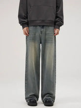 Men’s full size wide leg relaxed fit jeans in faded gray blue denim with subtle distressing and frayed hems