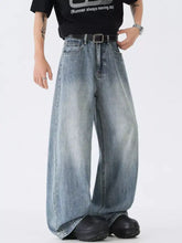 Men’s full size wide leg vintage wash jeans in faded light blue denim with classic stitching and a black belt
