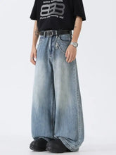 Men’s full size wide leg vintage wash jeans in faded blue denim with subtle distressing details