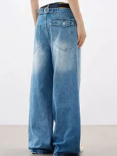 Men’s full size wide leg vintage wash jeans in faded blue denim with classic back pockets and a black belt shown from back side
