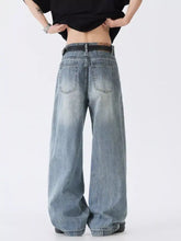 Men’s full size wide leg vintage wash denim jeans in faded blue with classic back pockets shown from the back side