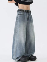 Men’s wide leg vintage wash jeans in faded blue denim with a black belt, available in full and plus sizes