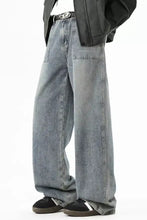 Men’s full size wide leg vintage wash jeans in light-wash denim with relaxed fit and visible stitching details