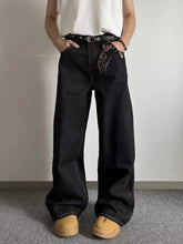 Men’s full size wide leg black denim jeans with relaxed fit and visible stitching made from premium cotton blend