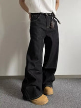 Men’s full size wide leg black denim jeans with visible stitching made from premium cotton blend fabric