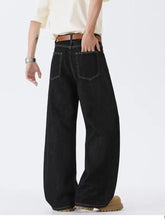 Men’s full size wide leg wash jeans in black denim with white stitching and brown leather belt