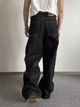 Men’s full size wide leg black denim jeans with white stitching and brown leather belt loop made of premium cotton blend