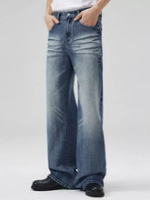Men’s full size wide-leg wash jeans in faded medium-blue denim with relaxed fit, subtle whiskering, and frayed hems