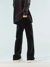 Men’s full size black corduroy wide leg jeans with zipper accent and subtle vertical ridges in a straight-leg cut