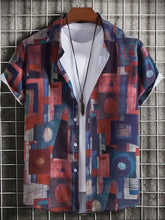 Mens geometric short sleeve button down shirt over white tee with necklace