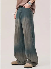 Men’s wide leg jeans with a gradient wash in teal to gray denim featuring subtle distressing details