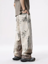 Beige men’s wide leg jeans with graffiti print and distressed layered textures in black ink style