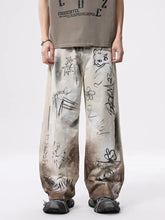 Men’s beige and brown gradient graffiti print wide leg jeans with black ink-style street art designs