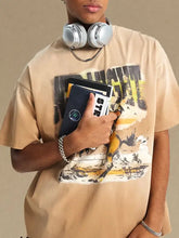 Young man in mens graphic round neck half sleeve tan t-shirt, headphones, books