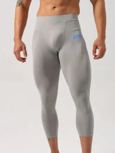 Mens high waist light gray compression capri pants with GYM on thigh