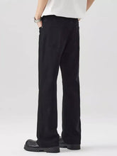 Men’s loose fit black denim jeans with straight-leg cut and subtle stitching details in modern design