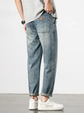 Men’s loose fit washed light-wash denim jeans with relaxed fit and rolled cuffs for casual comfort
