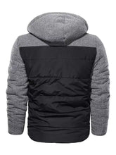 Men’s gray and black padded hooded winter coat with quilted body and textured knit sleeves for cold weather