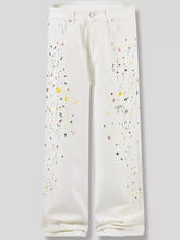 Men’s white denim paint splatter artistic wide leg jeans with yellow pink green and black paint splatters