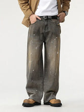 Men’s paint splatter wide leg denim jeans with faded distressed look and white paint splatter accents