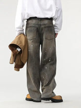 Washed gray denim men’s paint splatter wide leg jeans with relaxed fit and white paint splatter details