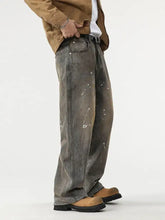 Men’s washed gray denim wide leg jeans with white paint splatter accents featuring a paint splatter wide design