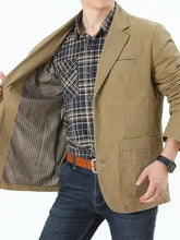 Men plus size khaki cotton button up lapel collar blazer with two front pockets worn over a plaid shirt