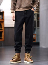 Men’s plus size black drawstring jeans with relaxed fit jogger style and cuffed ankles for casual wear
