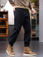 Men’s plus size casual drawstring jeans in black corduroy with red logo patches on pockets and a drawstring waist