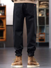 Men’s plus size black denim drawstring jeans showing back side with subtle red logo on the pocket
