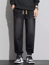 Men’s plus size casual black jogger jeans with beige drawstring waist and side pockets for comfortable wear