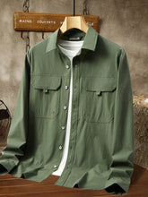 Men’s plus size casual lightweight olive green button-down shacket with long sleeves and white undershirt visible