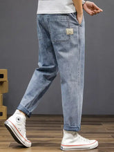 Men’s plus size casual loose fit light-wash denim wash jeans with rolled cuffs and a back side patch on the pocket