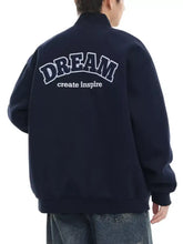 Back view of navy blue plus size varsity bomber jacket with white embroidered dream and create inspire text