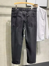 Men’s plus size dark gray denim distressed slim fit jeans with straight-leg cut and rolled cuffs