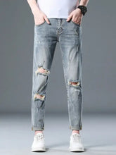 Men’s plus size light-wash denim distressed slim fit jeans with slight stretch, ripped knees, and rolled cuffs