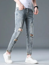 Men’s plus size slim fit distressed jeans in light-wash denim with slight stretch ripped knees and rolled cuffs