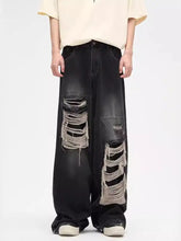 Men’s plus size black distressed wide leg jeans with layered ripped patches on the thighs in denim material