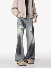 Men’s plus size distressed wide leg jeans in faded denim with intentional tears and a relaxed fit design