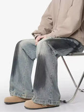 Men’s plus size distressed wide leg denim jeans with faded gradient wash from light blue to dark indigo
