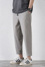 Mens plus size drawstring pants in grey with white sneakers