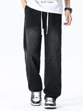 Men’s plus size drawstring wide leg black denim pants with a faded distressed texture and white drawstrings