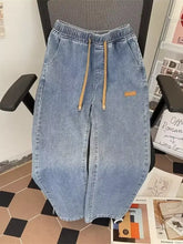 Men’s plus size light-wash denim wide leg jeans with drawstring waist and tan cord accents in a casual style