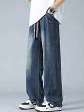 Men’s plus size dark blue denim drawstring jeans with faded wash visible stitching and relaxed wide-leg cut