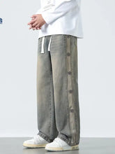 Men’s plus size drawstring wide leg gray denim pants with faded wash and decorative black star buttons down seam